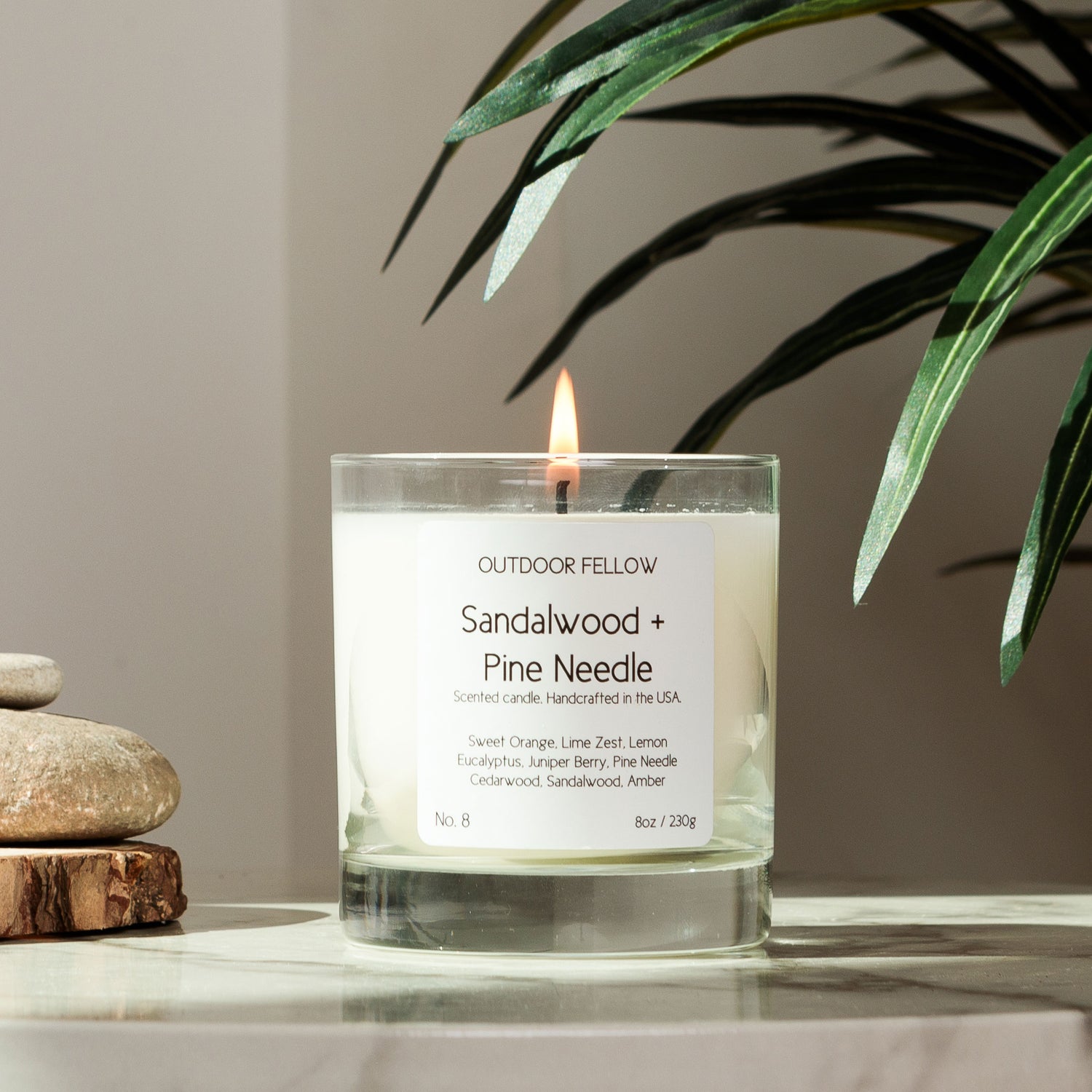 Sandalwood and Pine Needle scented candle on a marble table