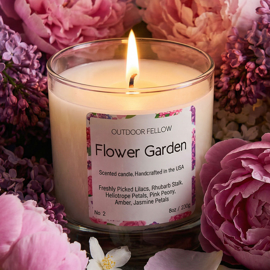 Outdoor Fellow Flower Garden candle surrounded by blooming lilacs, pink peonies, and jasmine petals.