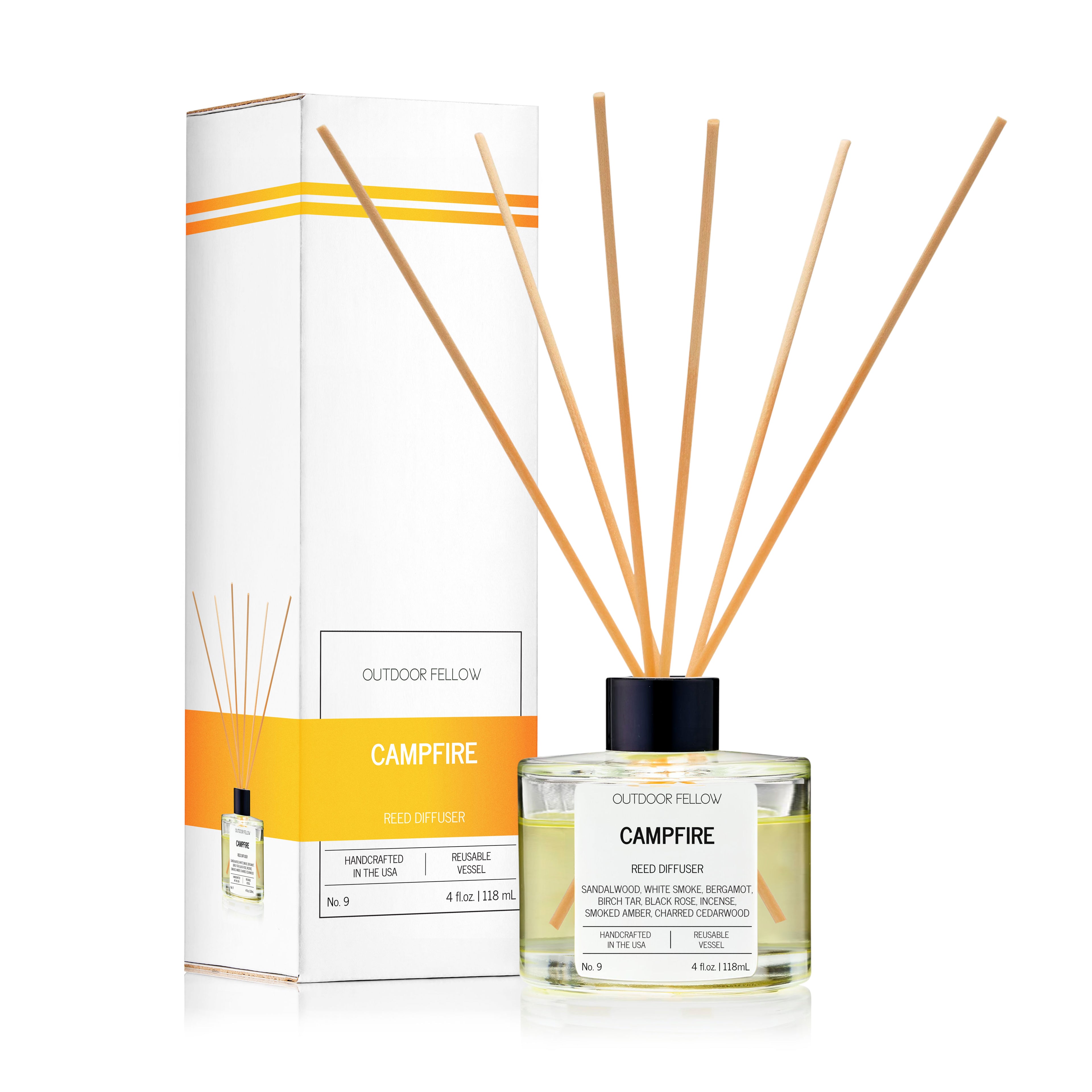 Outdoor Fellow Campfire reed diffuser with packaging box, featuring a clear glass bottle with natural reeds and a label listing scent notes including sandalwood, white smoke, incense, and charred cedarwood.