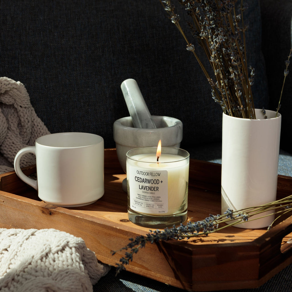 Cedarwood + Lavender Candle, mug, and decorative items on a wooden tray with a cozy background
