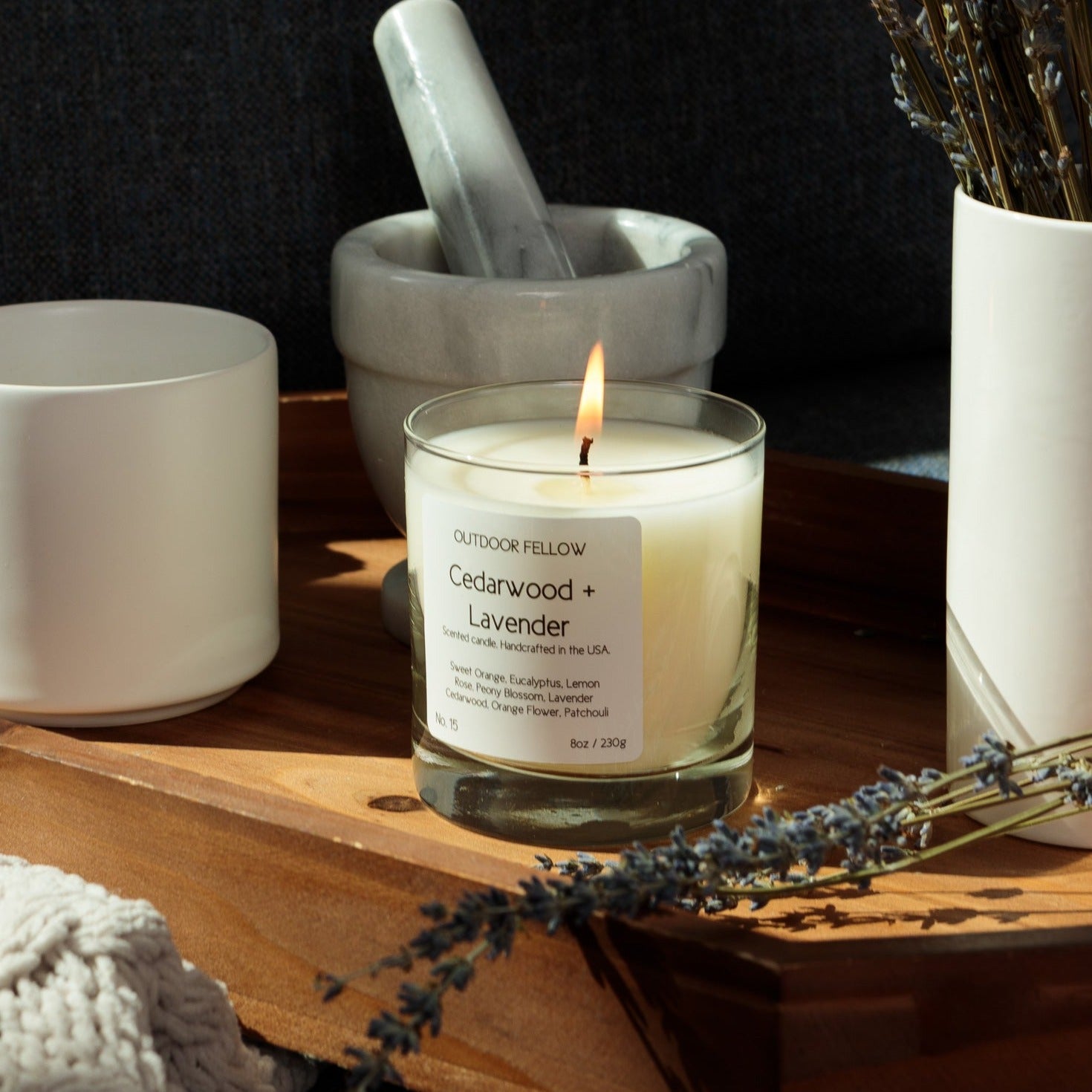 Cedarwood and Lavender candle on a wooden tray in a bedroom