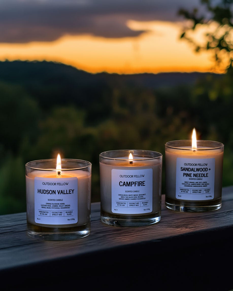 Hudson Valley, Campfire, and Sandalwood + Pine Needle scented candles on a wooden banner
