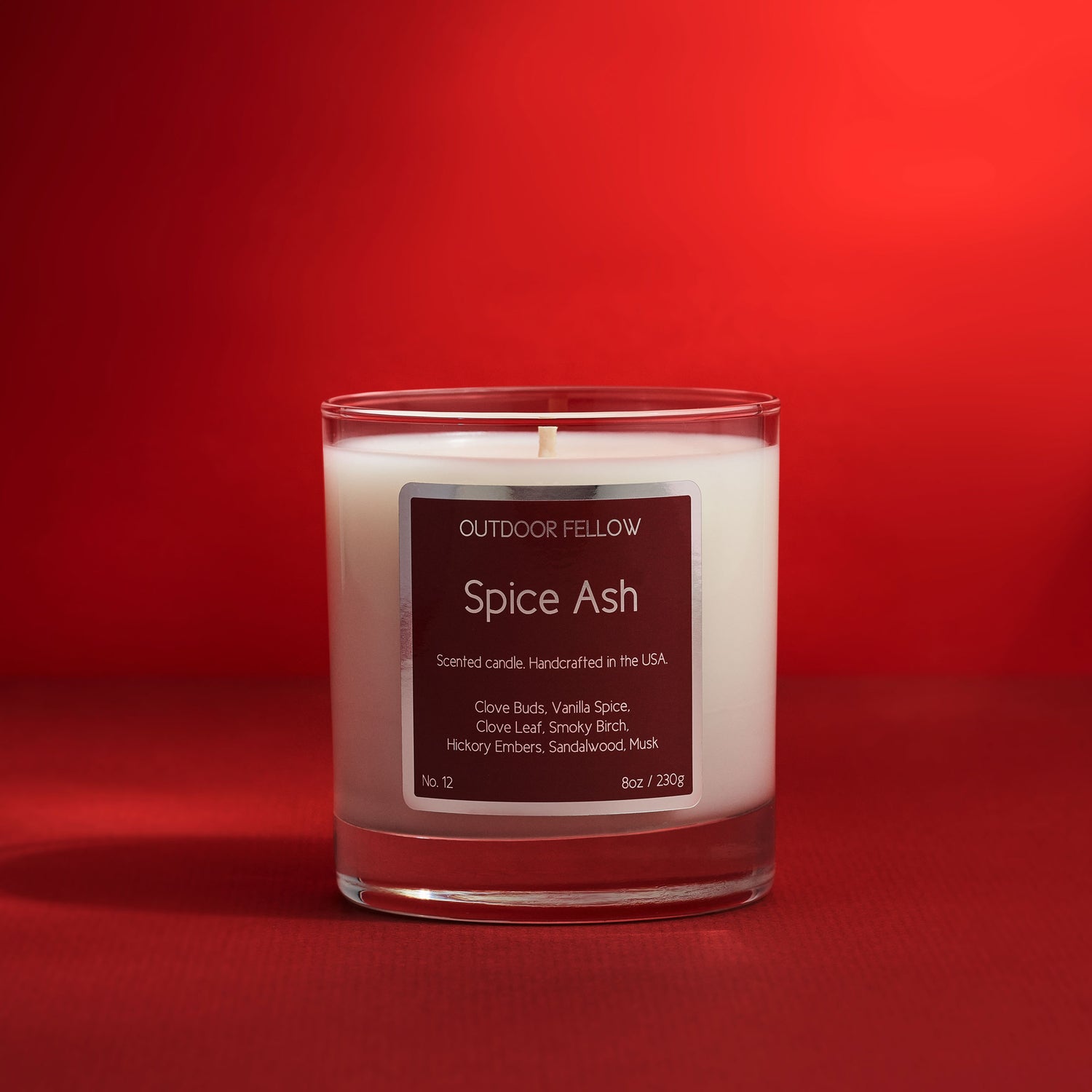 Spice Ash scented candle on a red background
