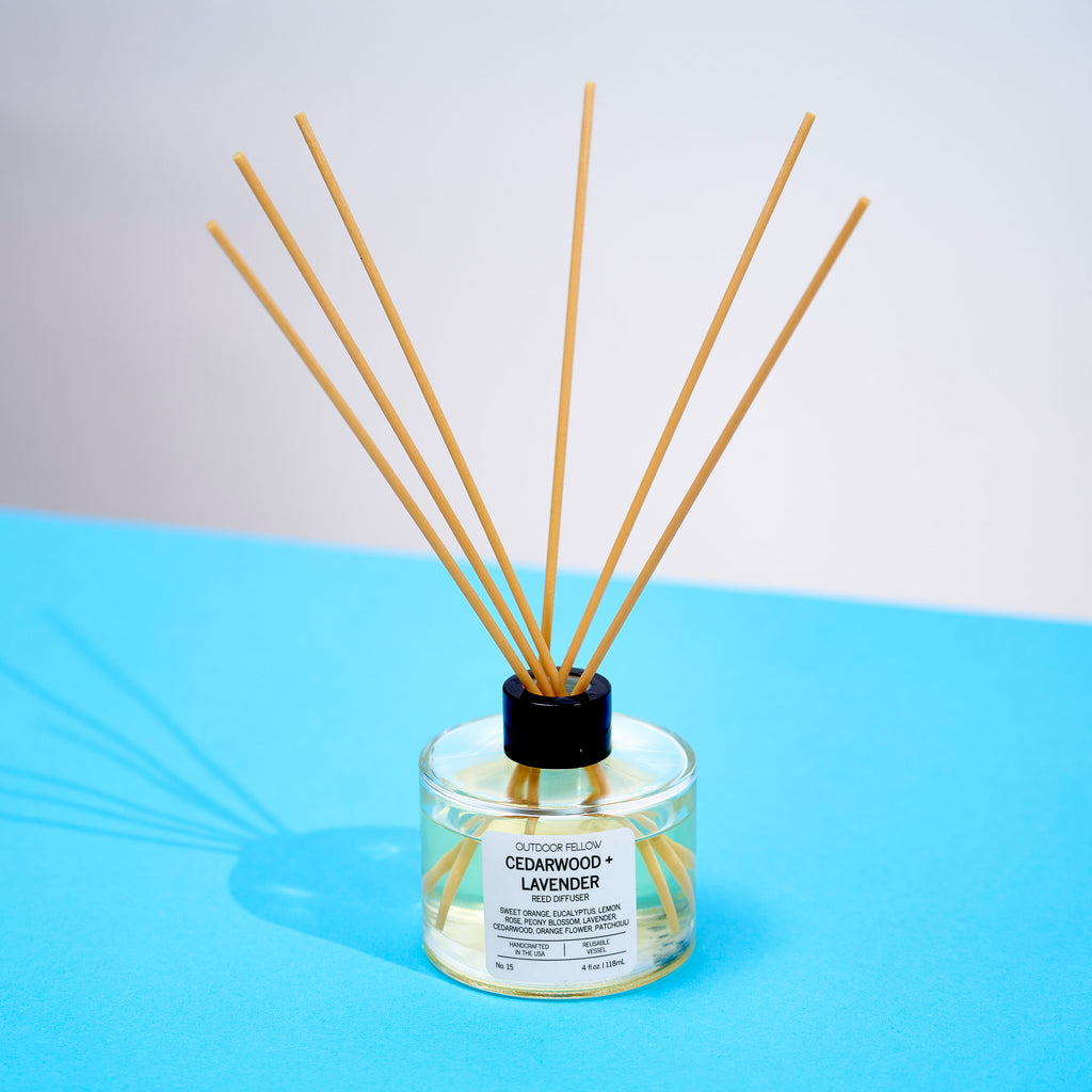 Cedarwood and Lavender reed diffuser on a blue surface