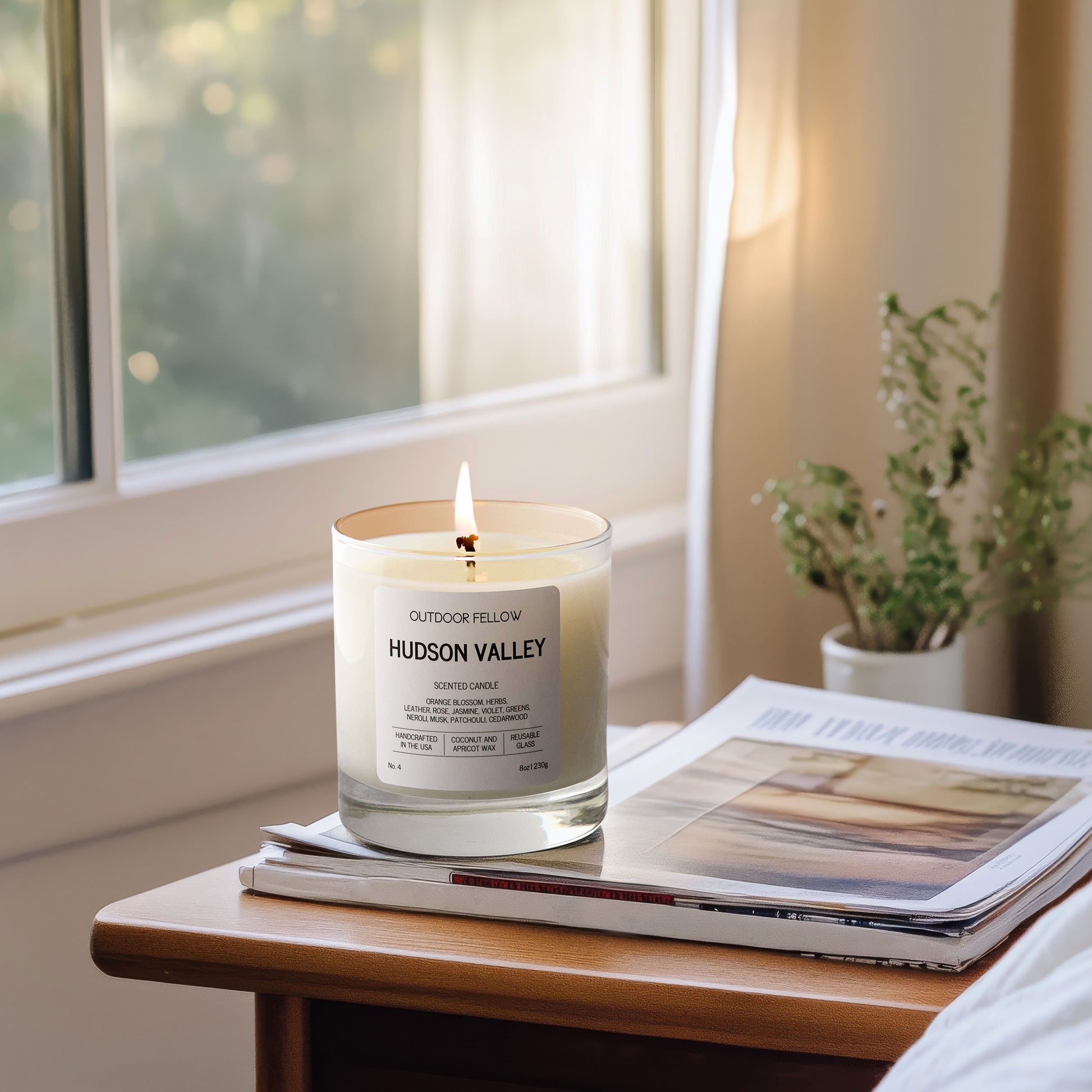 Hudson Valley scented candle on a bedside table