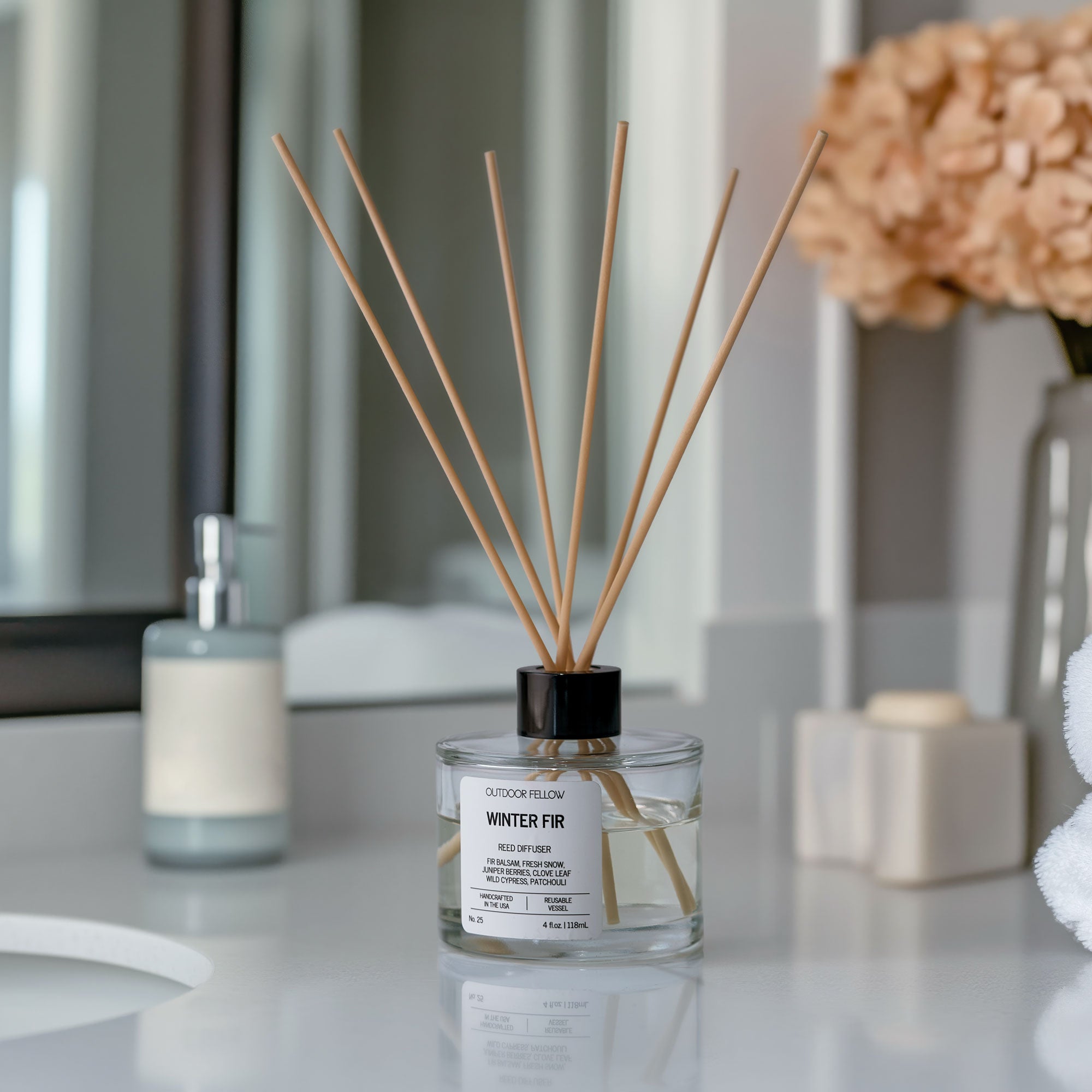 Winter Fir reed diffuser on a bathroom counter