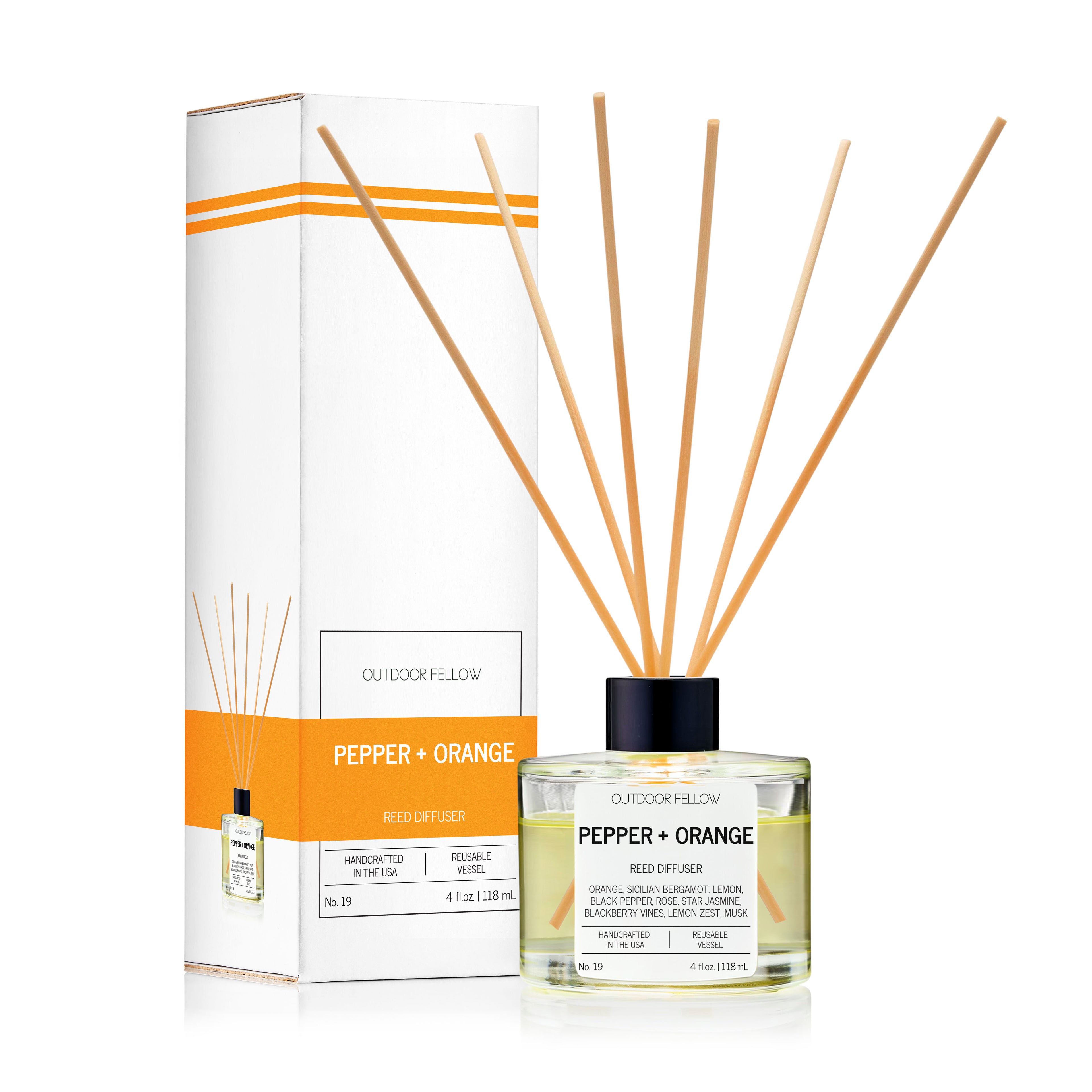 Outdoor Fellow Pepper + Orange reed diffuser with packaging box, featuring a clear glass bottle, natural reeds, and a label listing scent notes such as orange, bergamot, lemon, black pepper, and neroli.