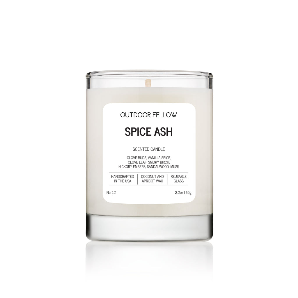 Candle labeled 'Spice Ash' by Outdoor Fellow on a white background