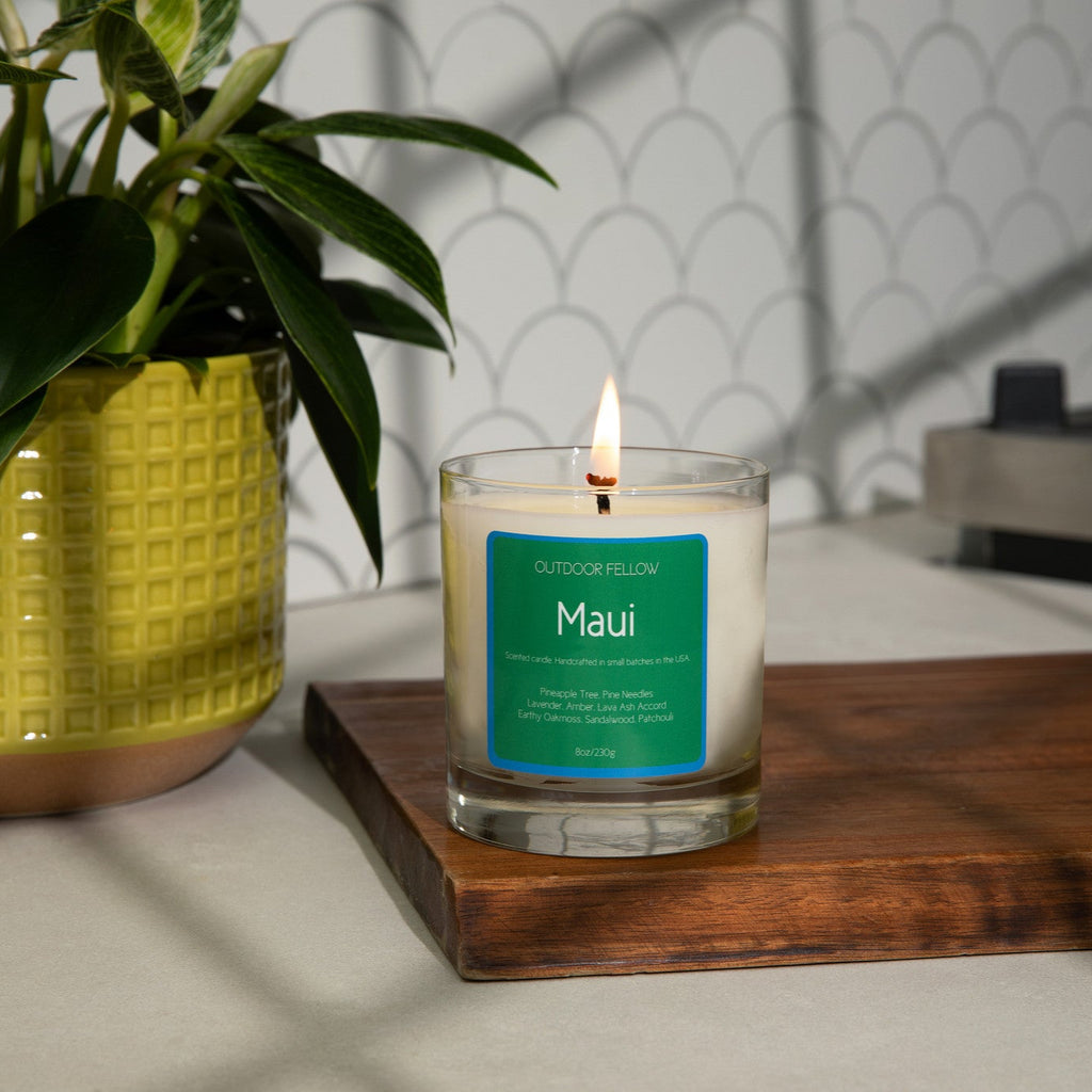 Maui scented candle on a wooden cutting board in a kitchen
