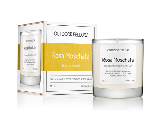 Rosa Moschata scented candle next to packaging on white background